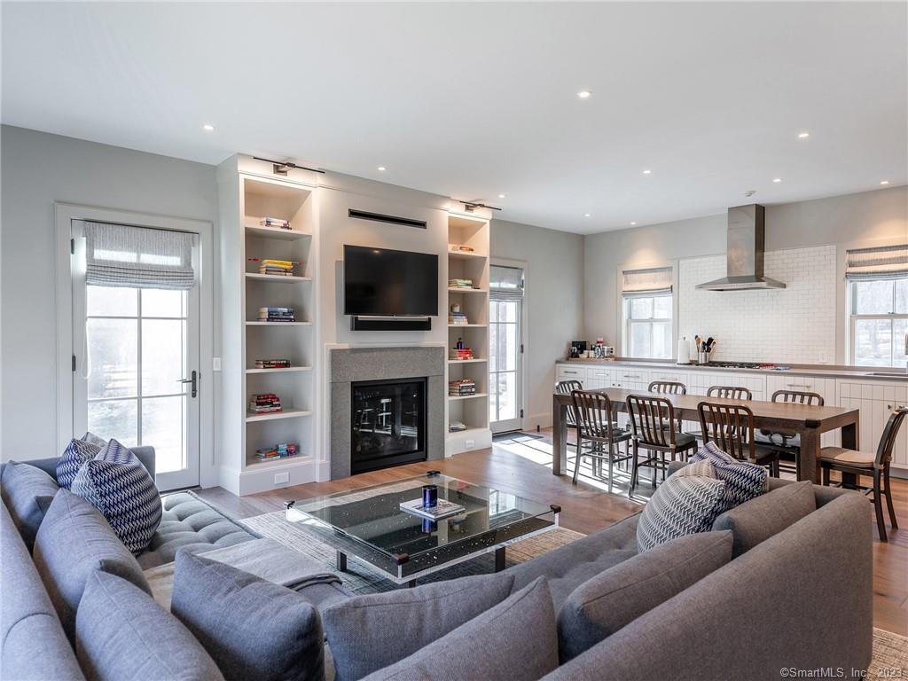 126 River Road Washington, CT 06794 - Photo 13 of 32 a living room with furniture a flat screen tv and a fireplace