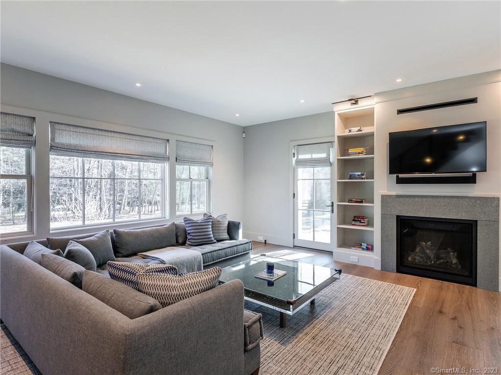 126 River Road Washington, CT 06794 - Photo 14 of 32 a living room with furniture a flat screen tv and a fireplace