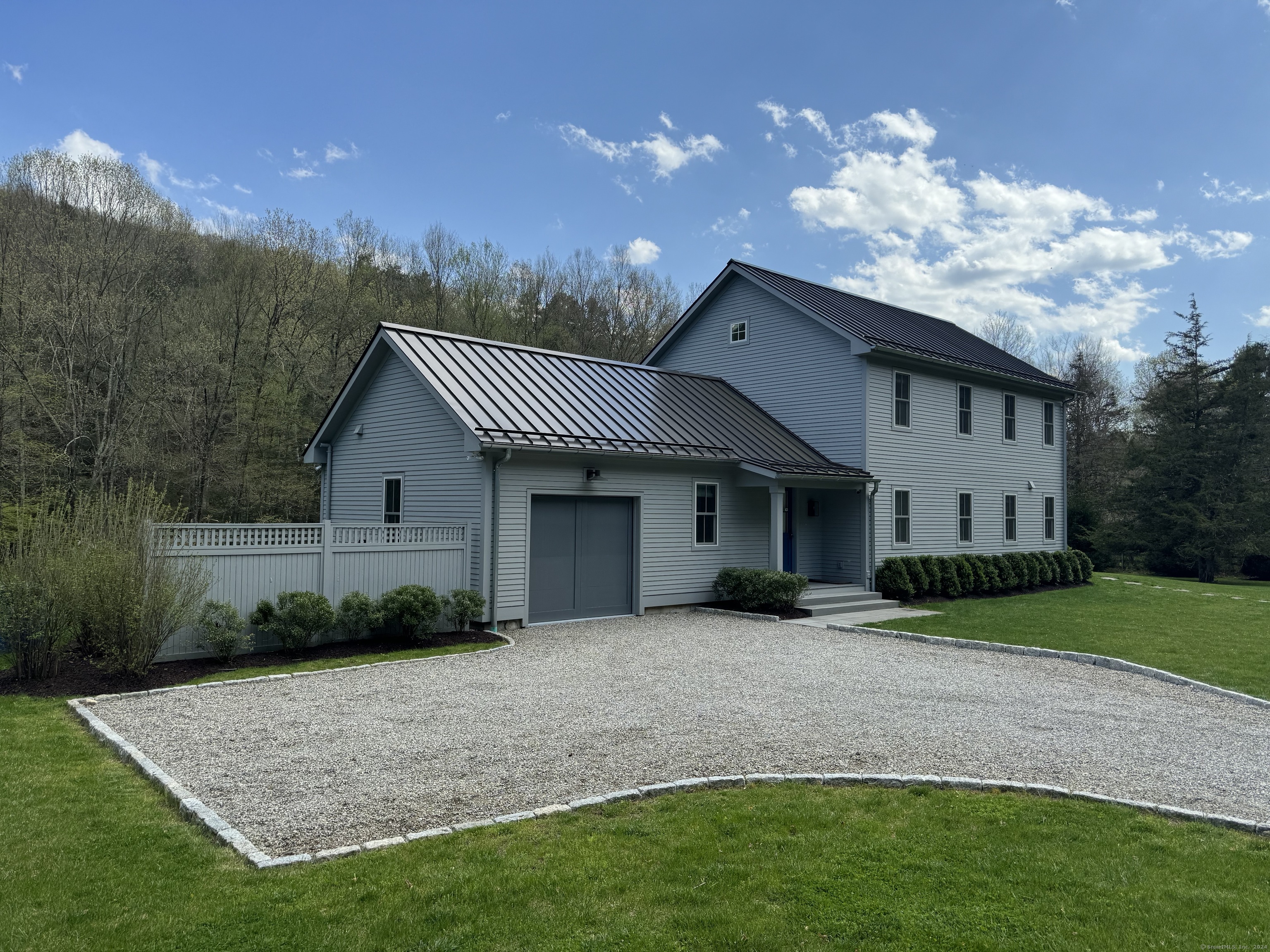 126 River Road Washington, CT 06794 - Photo 2 of 32 a front view of a house with a yard