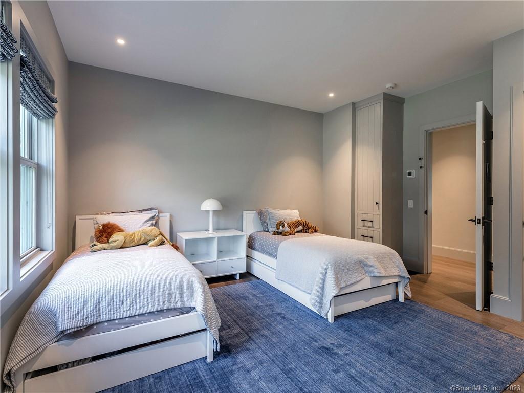 126 River Road Washington, CT 06794 - Photo 26 of 32 a bedroom with two beds and a night stand