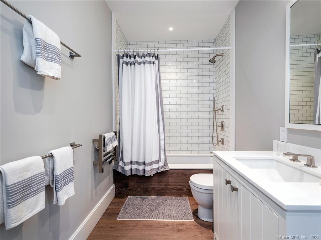 126 River Road Washington, CT 06794 - Photo 27 of 32 a spacious bathroom with a granite countertop sink a toilet and shower