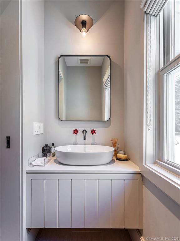 126 River Road Washington, CT 06794 - Photo 7 of 32 a bathroom with a sink and a mirror