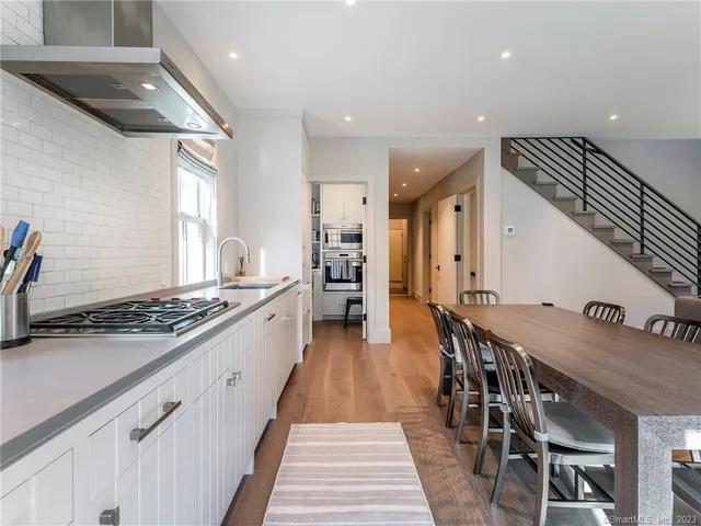 a kitchen with stainless steel appliances a stove a sink dishwasher and a refrigerator