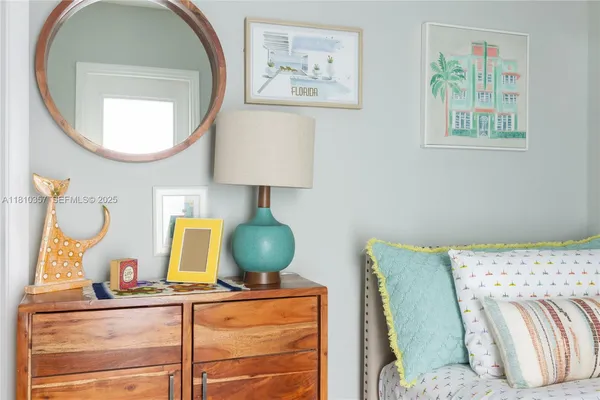 a living room with a mirror and a lamp