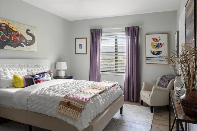 a bedroom with a bed and a couch