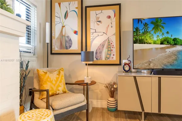 a living room with furniture and wall paintings