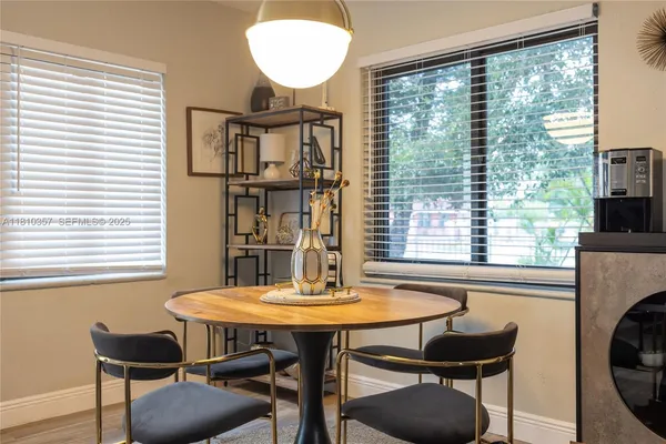 a view of a dining room with furniture and window