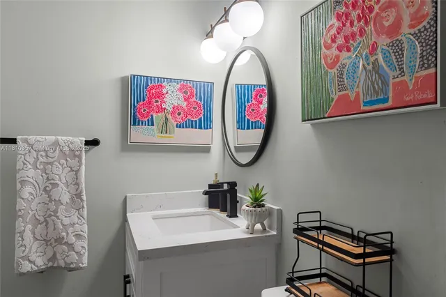 a bathroom with a sink mirror and vanity