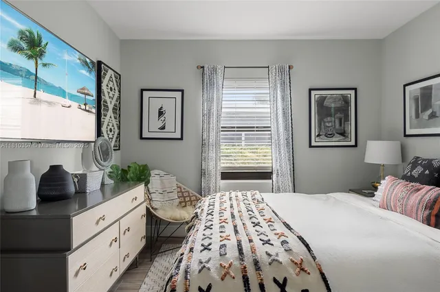 a bedroom with a large bed and a window