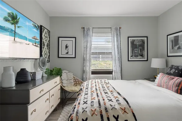 a bedroom with a large bed and a window