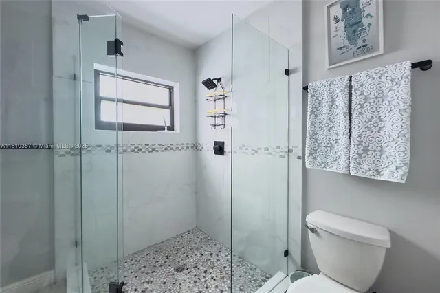 a bathroom with a shower and toilet