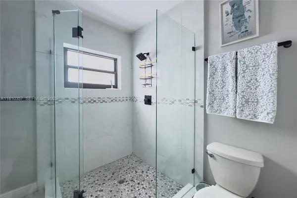 a bathroom with a shower and toilet