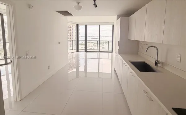 a kitchen with stainless steel appliances a sink a stove and a window