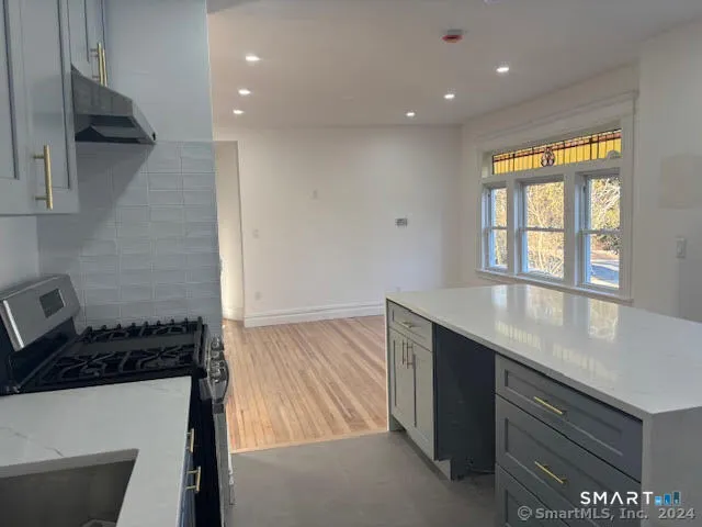 a kitchen with a sink and a refrigerator