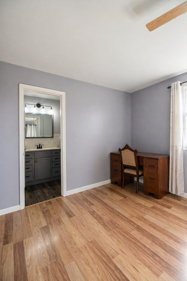 1751 Maples Road Dixon, IL 61021 - Photo 9 of 23 a bedroom with a bed and a view of kitchen
