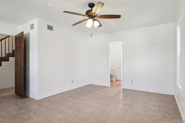 a bathroom with a sink a toilet a shower and a window