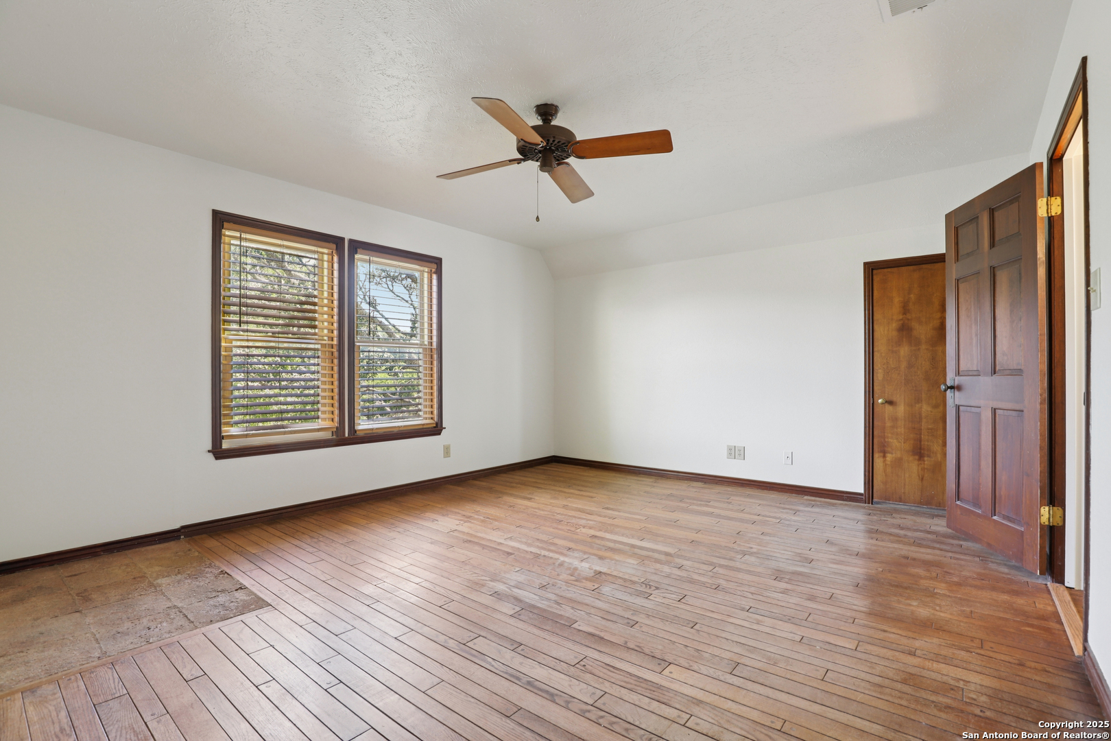 4380 Bear Springs Road Pipe Creek, TX 78063 - Photo 18 of 60 a view of an empty room with wooden floor and a window