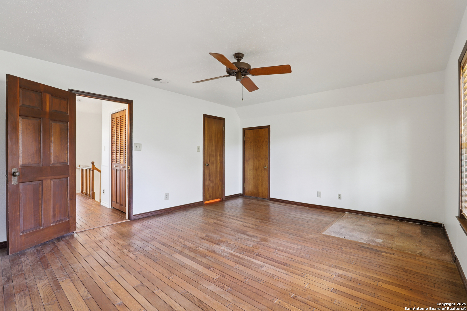 4380 Bear Springs Road Pipe Creek, TX 78063 - Photo 19 of 60 a view of empty room with wooden floor and ceiling fan