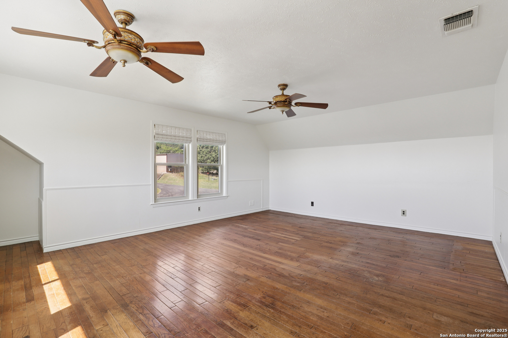 4380 Bear Springs Road Pipe Creek, TX 78063 - Photo 22 of 60 an empty room with fan and windows
