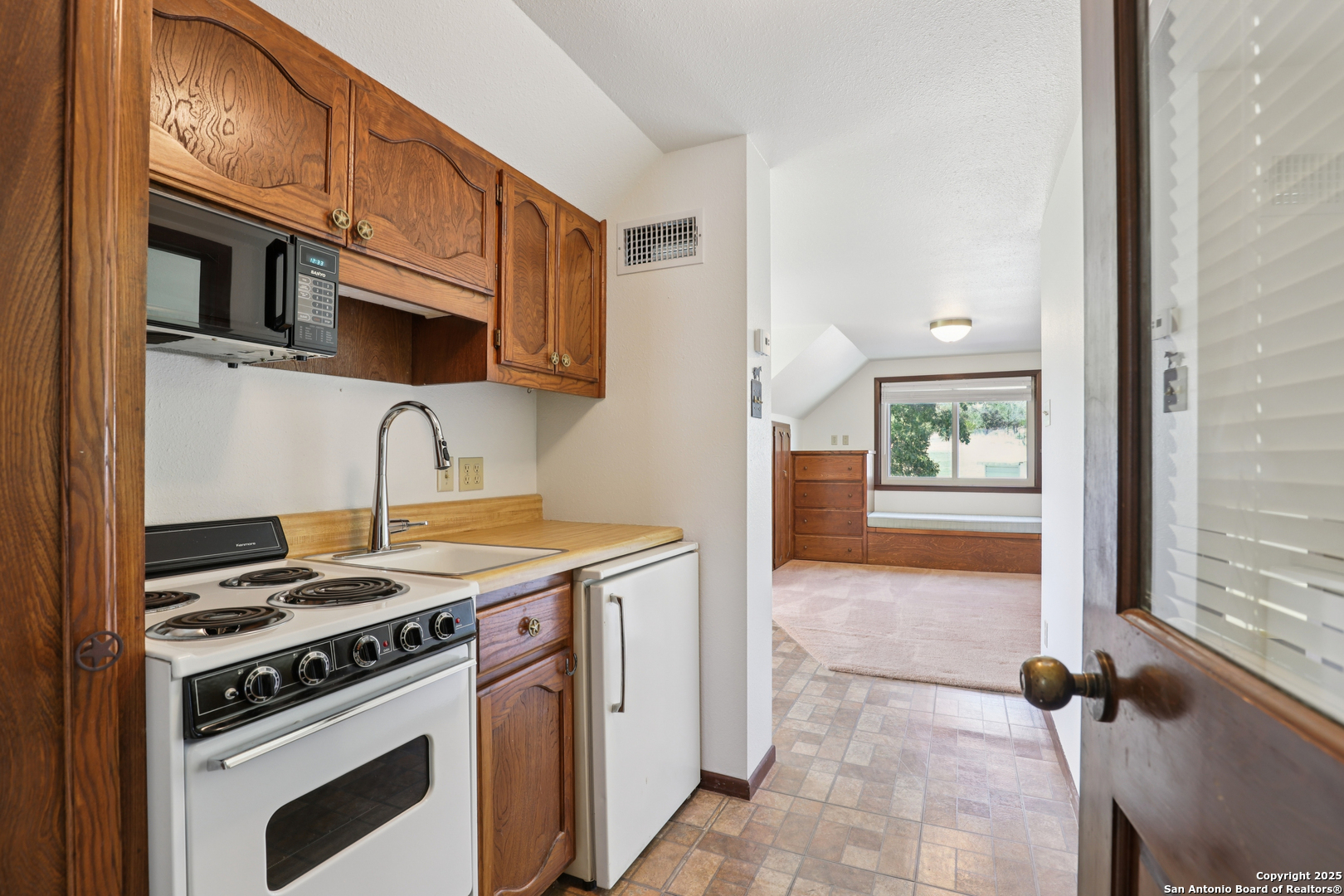 4380 Bear Springs Road Pipe Creek, TX 78063 - Photo 25 of 60 a kitchen with stainless steel appliances granite countertop a stove and a microwave