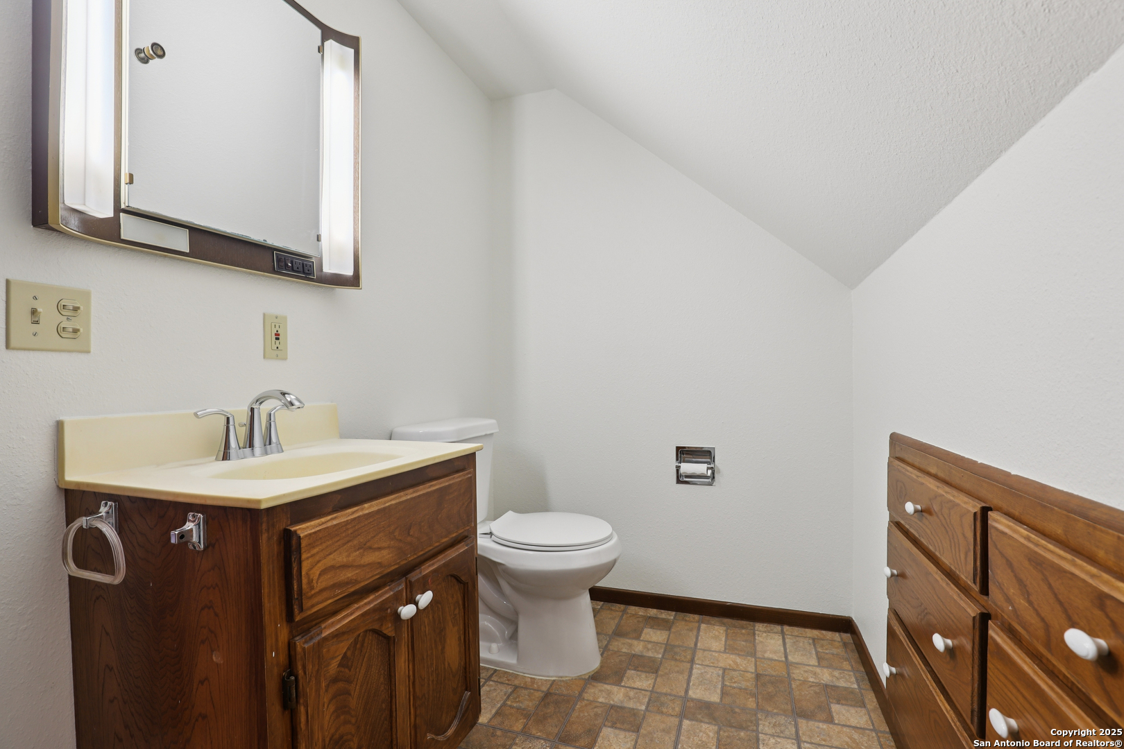 4380 Bear Springs Road Pipe Creek, TX 78063 - Photo 28 of 60 a bathroom with a sink a toilet and mirror