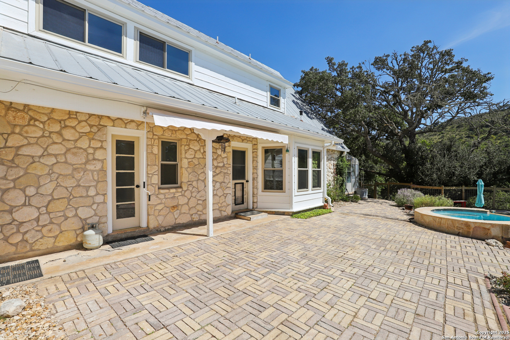 4380 Bear Springs Road Pipe Creek, TX 78063 - Photo 32 of 60 a view of a house with backyard and sitting area