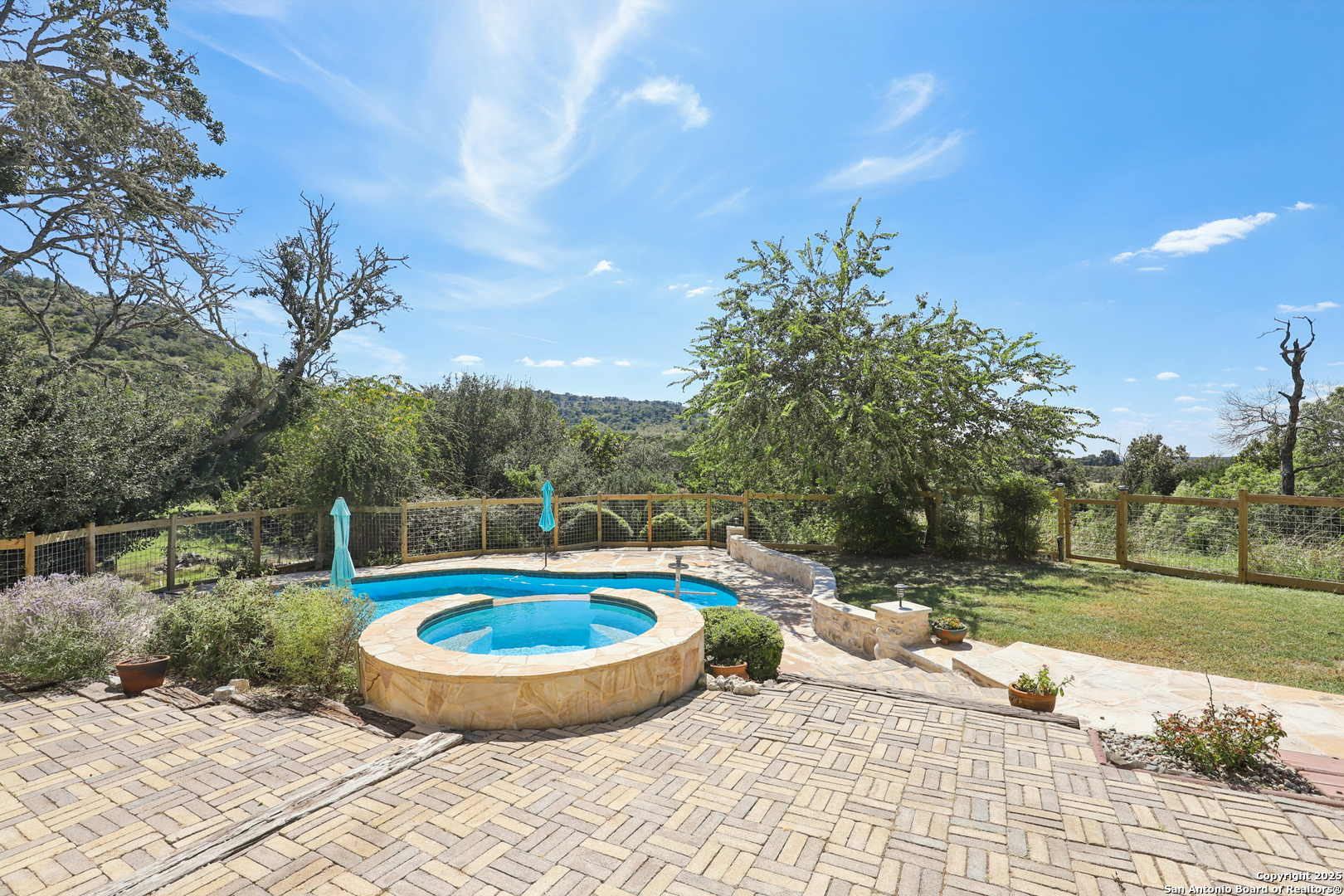 4380 Bear Springs Road Pipe Creek, TX 78063 - Photo 34 of 60 a view of a swimming pool with a yard