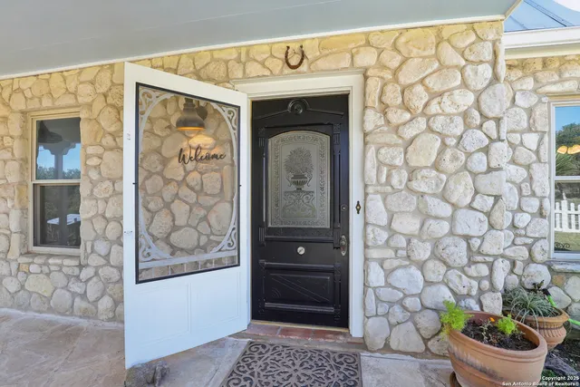 a view of a hallway with wooden floor and entryway