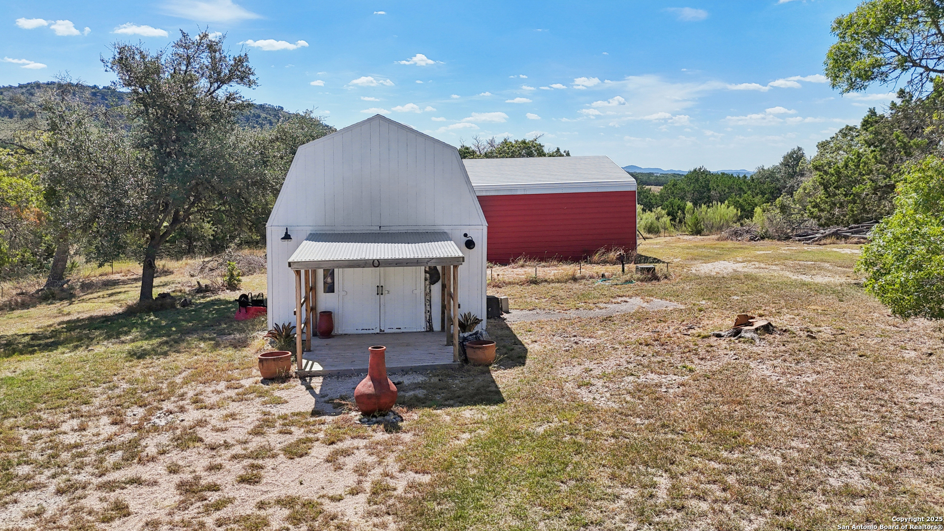 4380 Bear Springs Road Pipe Creek, TX 78063 - Photo 43 of 60 a view of a small house in the middle of a yard
