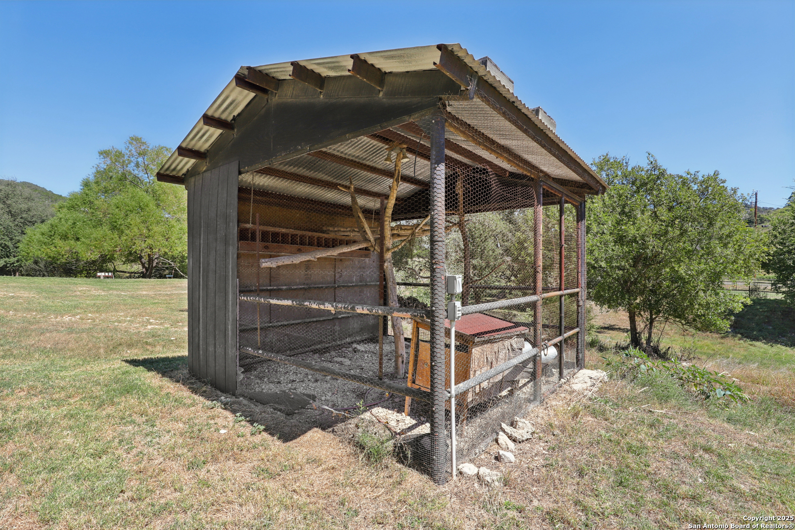 4380 Bear Springs Road Pipe Creek, TX 78063 - Photo 44 of 60 a view of a wooden door and a yard