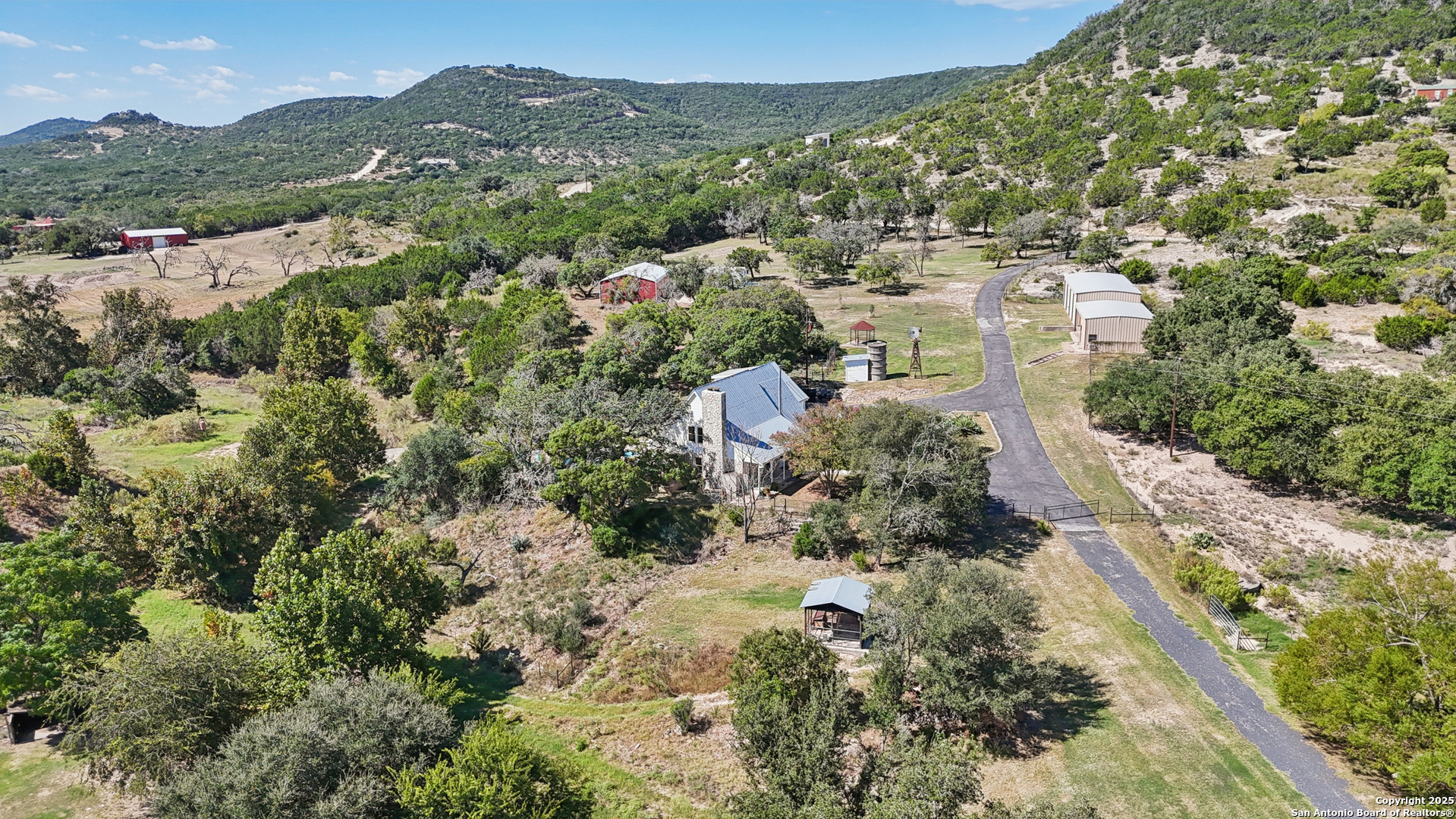 4380 Bear Springs Road Pipe Creek, TX 78063 - Photo 50 of 60 an aerial view of residential houses with outdoor space and trees