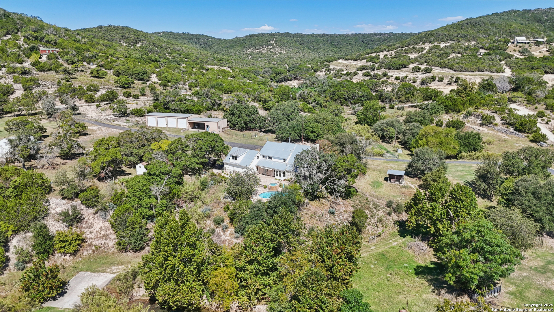 4380 Bear Springs Road Pipe Creek, TX 78063 - Photo 51 of 60 an aerial view of residential houses with outdoor space and trees