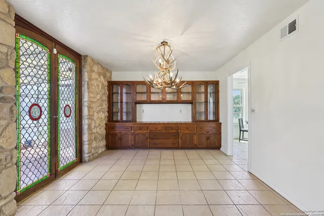 a dining room with furniture and window