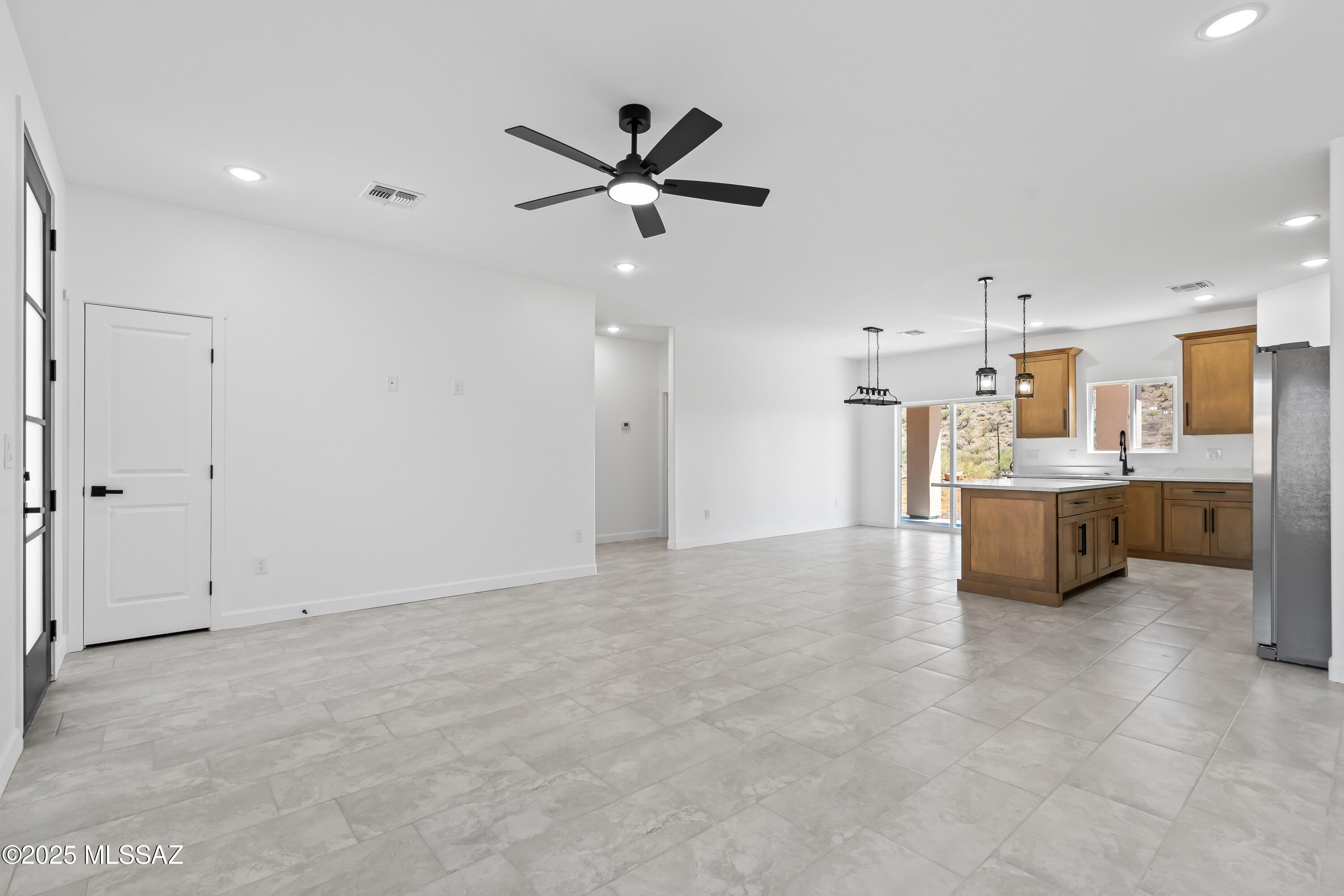 1667 Ave Calamar Rio Rico, AZ 85648 - Photo 8 of 33 a view of a kitchen with a sink and dishwasher cabinet a refrigerator