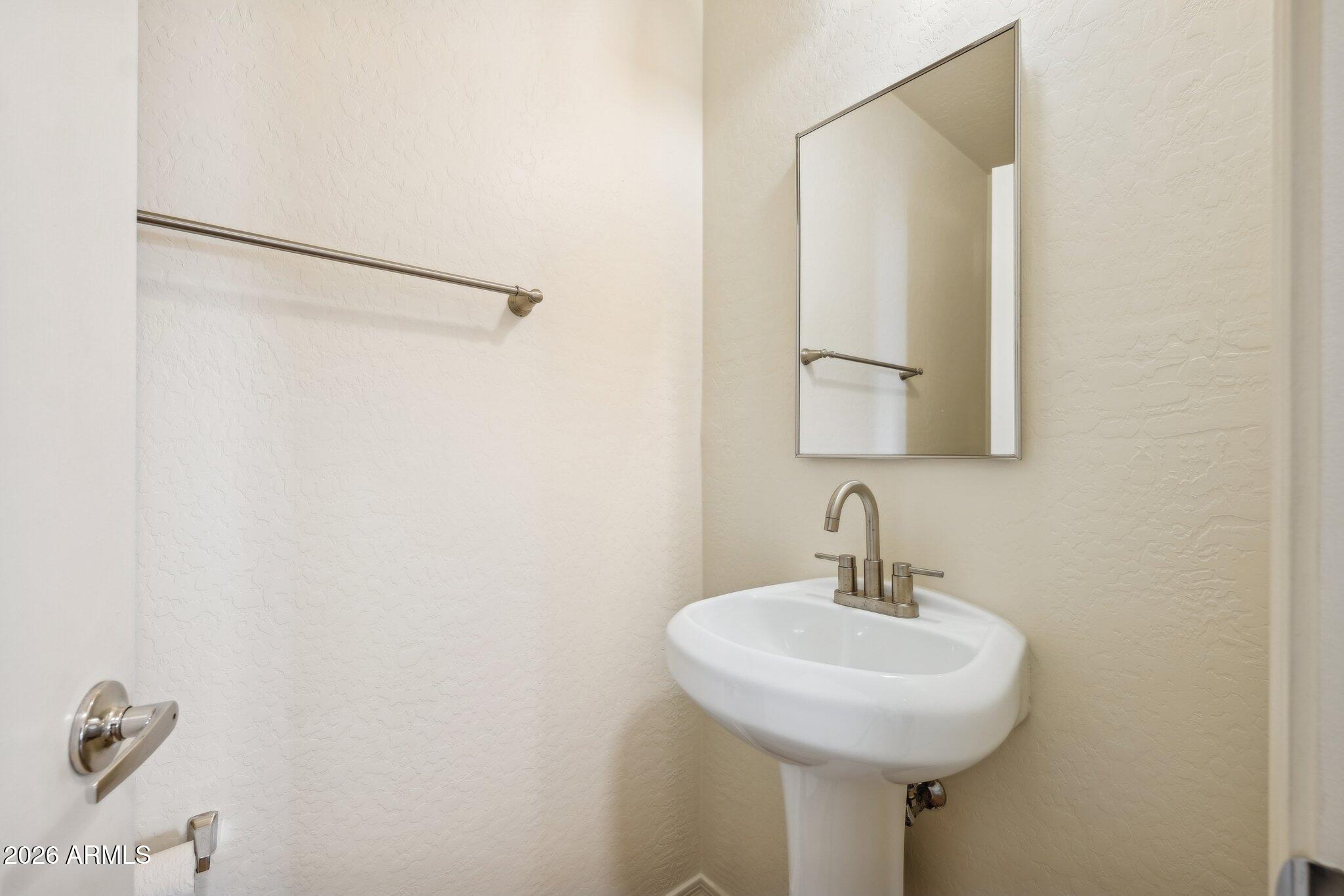 4034 East Chambers Street Phoenix, AZ 85040 - Photo 11 of 26 a bathroom with a sink and a mirror
