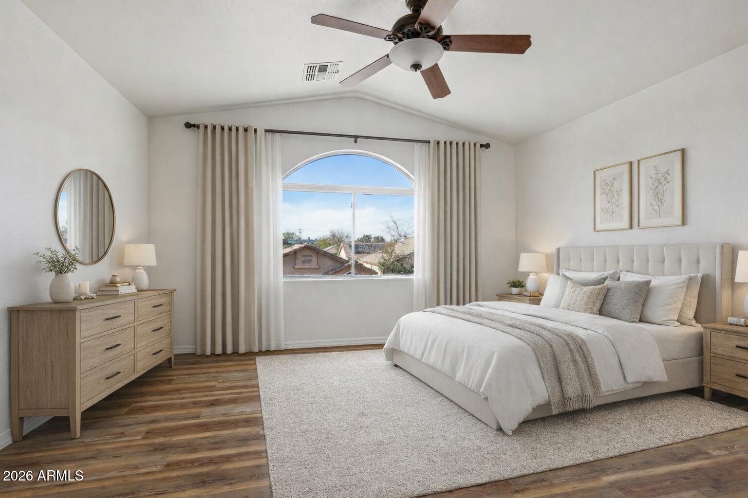 4034 East Chambers Street Phoenix, AZ 85040 - Photo 13 of 26 a bedroom with a large bed and a chandelier