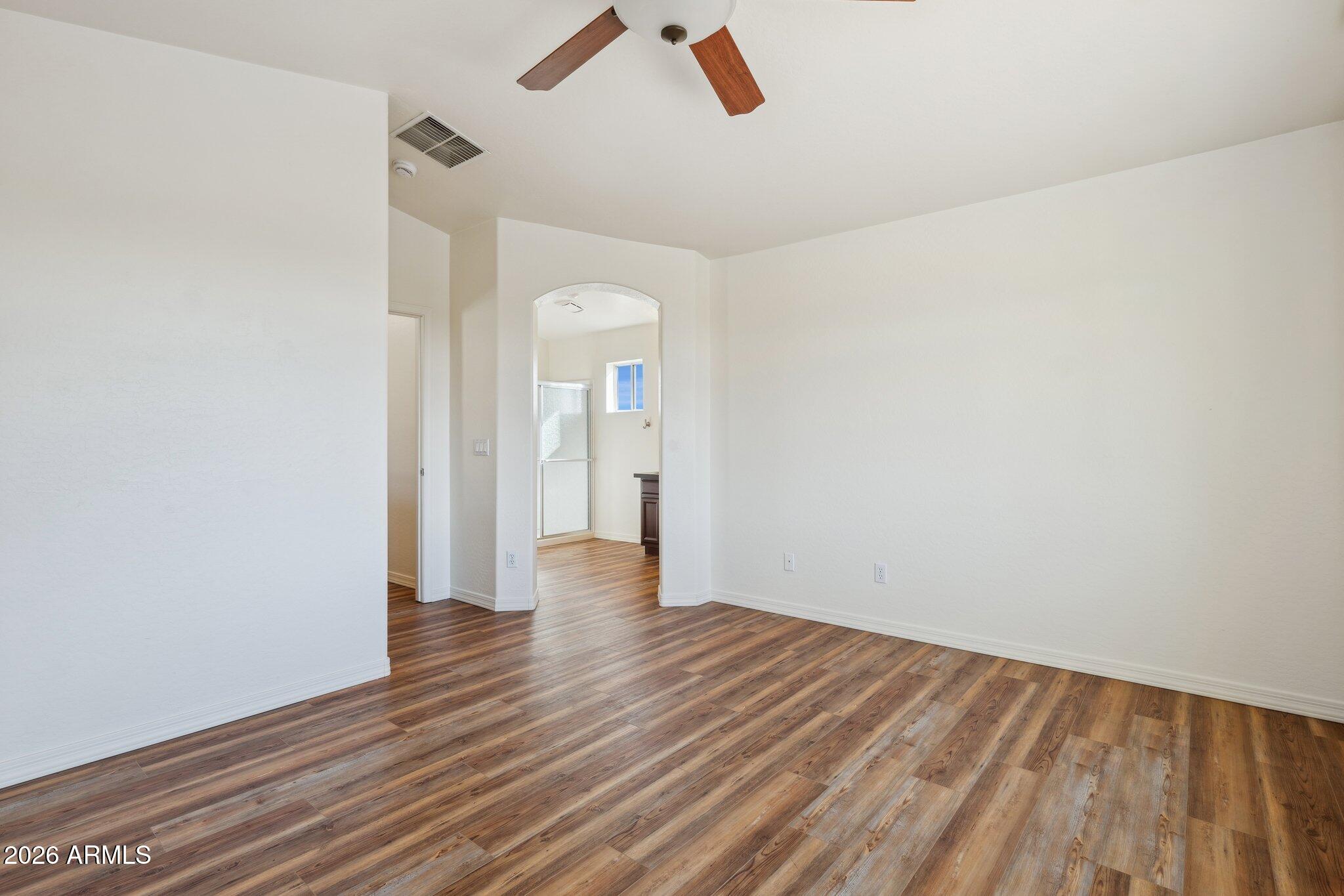 4034 East Chambers Street Phoenix, AZ 85040 - Photo 14 of 26 an empty room with wooden floor and windows