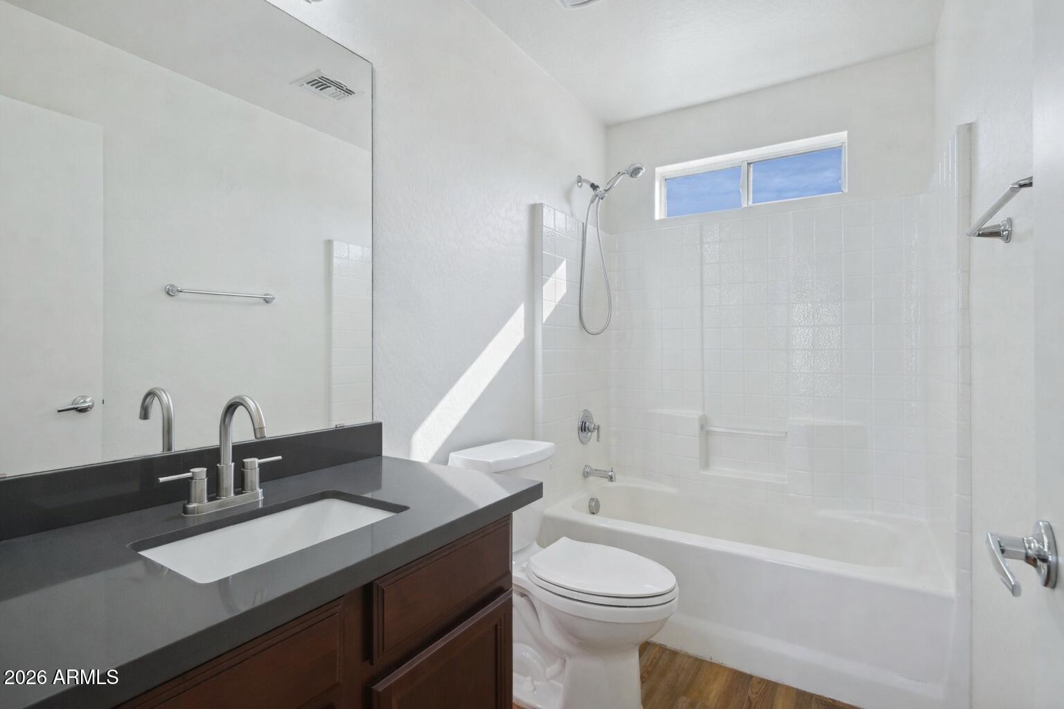4034 East Chambers Street Phoenix, AZ 85040 - Photo 18 of 26 a bathroom with a sink a toilet and a bathtub
