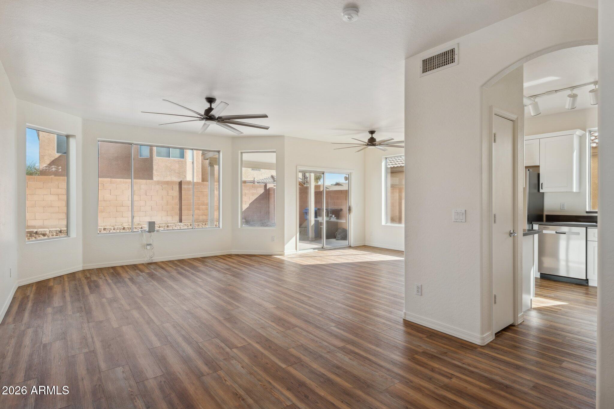 4034 East Chambers Street Phoenix, AZ 85040 - Photo 6 of 26 a view of an empty room with wooden floor and a window