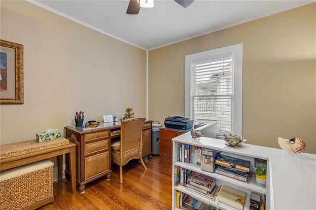 a bedroom with a bed table closet and a window