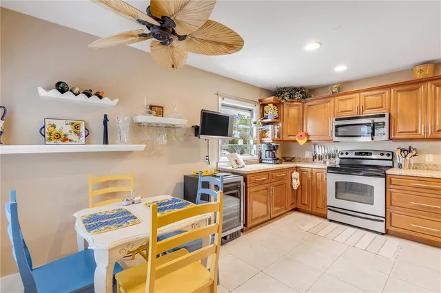 a kitchen with refrigerator and cabinets