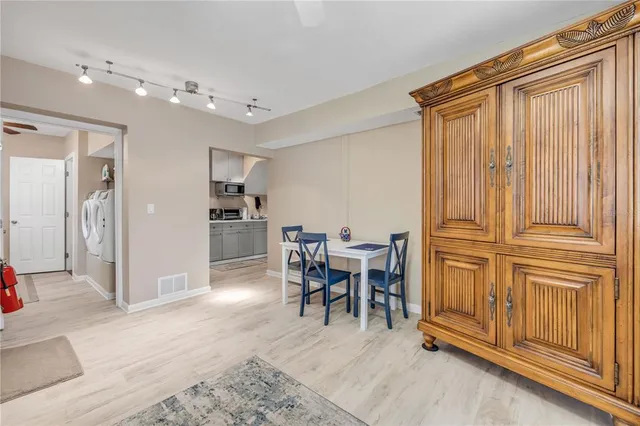 a kitchen with sink a microwave and cabinets