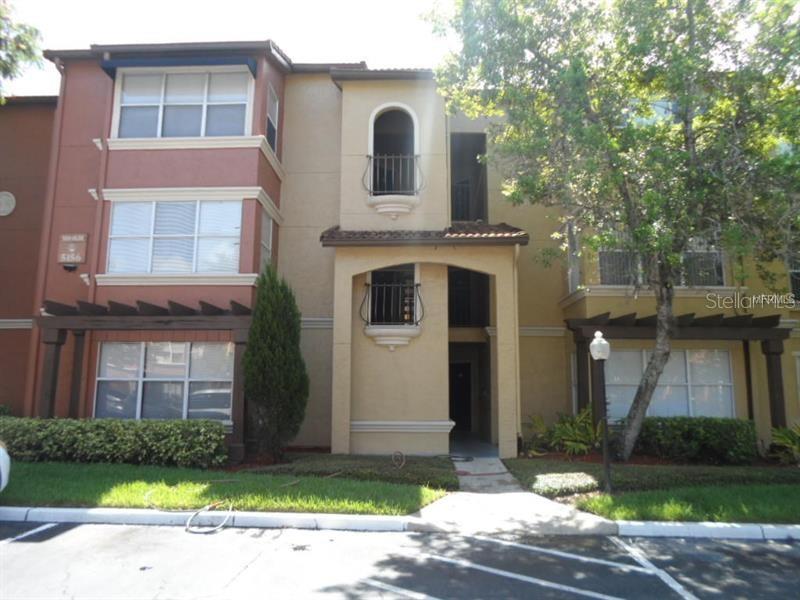 5112 Conroy Road, Unit 326 Orlando, FL 32811 - Photo 1 of 1 a front view of a house with a yard and garage