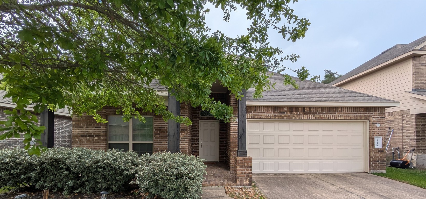 front view of a house with a tree