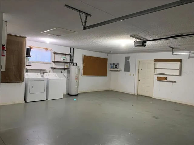 a view of a kitchen with refrigerator and white cabinets