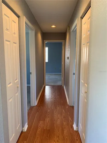 a view of gallery with wooden floor