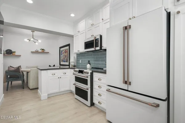 a kitchen with stainless steel appliances a refrigerator stove and sink