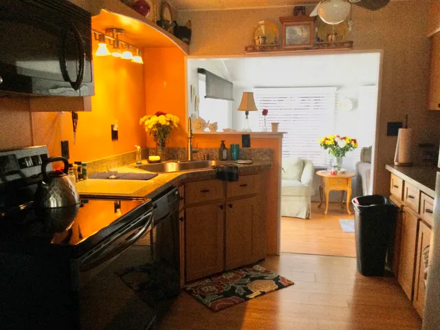 a kitchen with a sink appliances and cabinets