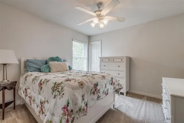 a living room with furniture and a ceiling fan