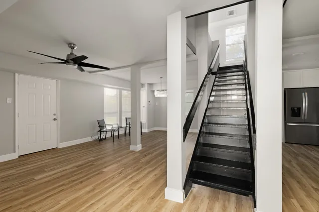 a view of entryway and hall with wooden floor